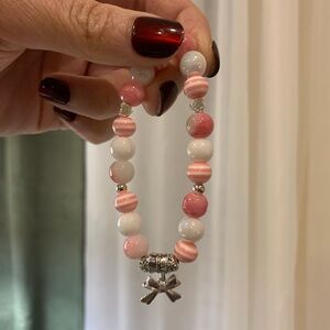 Pink and White Beaded Bracelet with Bow Charm